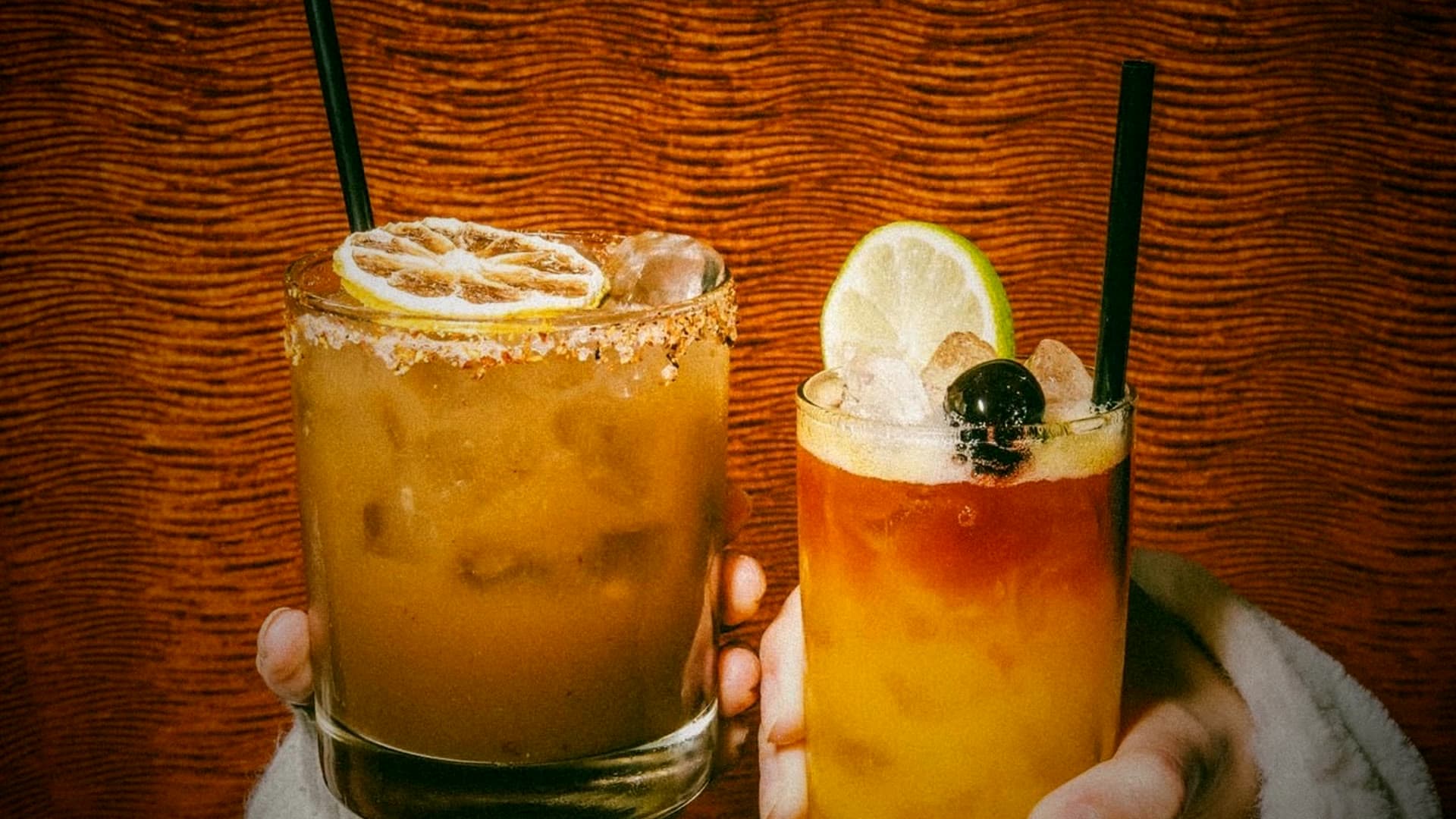 Two craft cocktails with citrus garnish, served at an Ashoka celebration